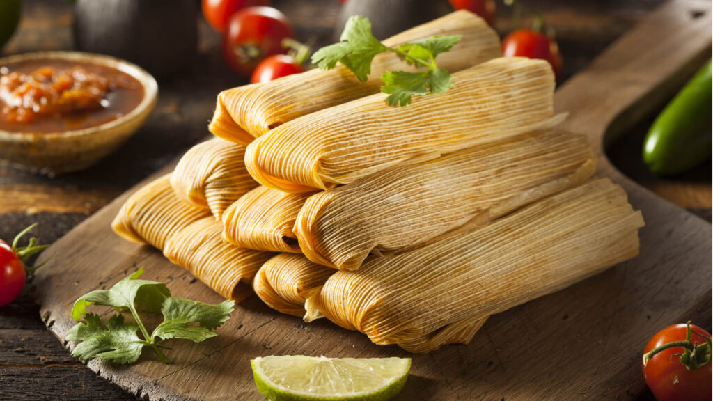 Red pork tamales made with fluffy masa and red chile sauce, perfect for holiday gatherings.